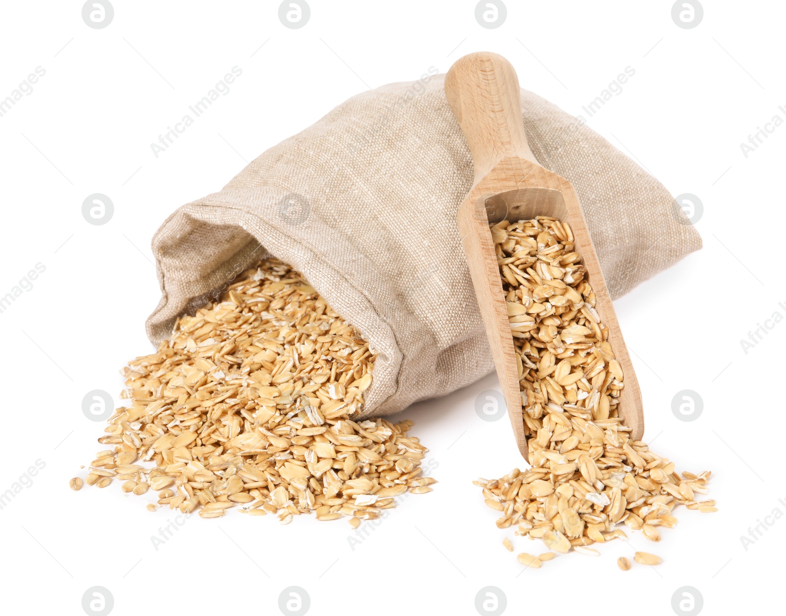 Photo of Dry oat flakes, overturned burlap sack and wooden scoop isolated on white