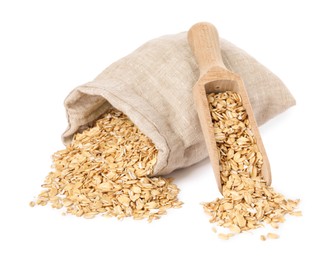 Photo of Dry oat flakes, overturned burlap sack and wooden scoop isolated on white