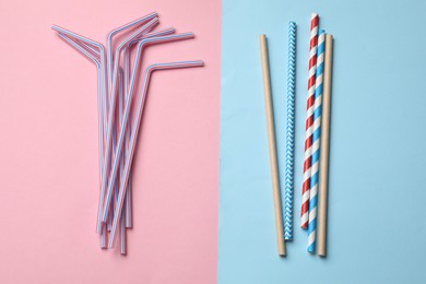 Photo of Plastic and bamboo drinking straws on color background, flat lay