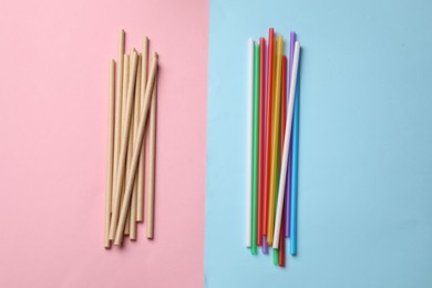 Photo of Plastic and bamboo drinking straws on color background, flat lay