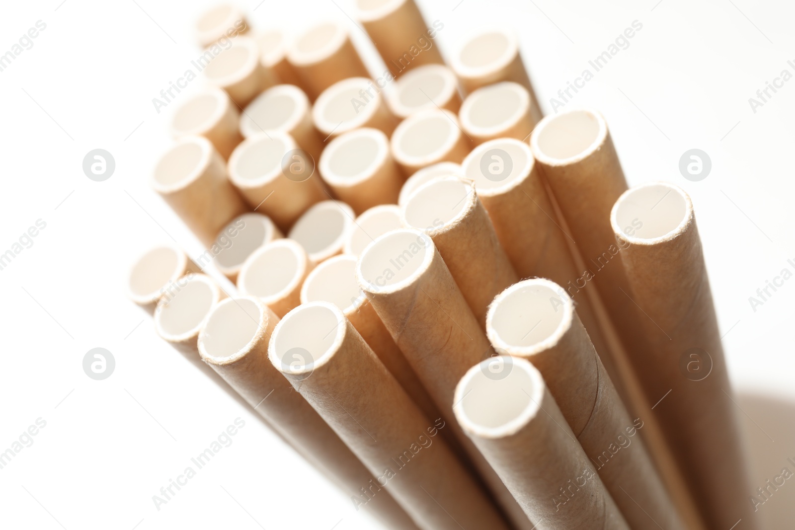 Photo of Many bamboo drinking straws on white background, closeup