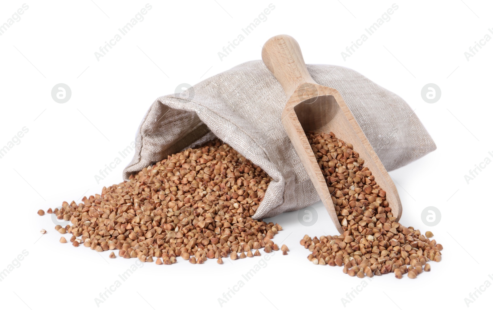 Photo of Raw buckwheat in burlap with scoop isolated on white