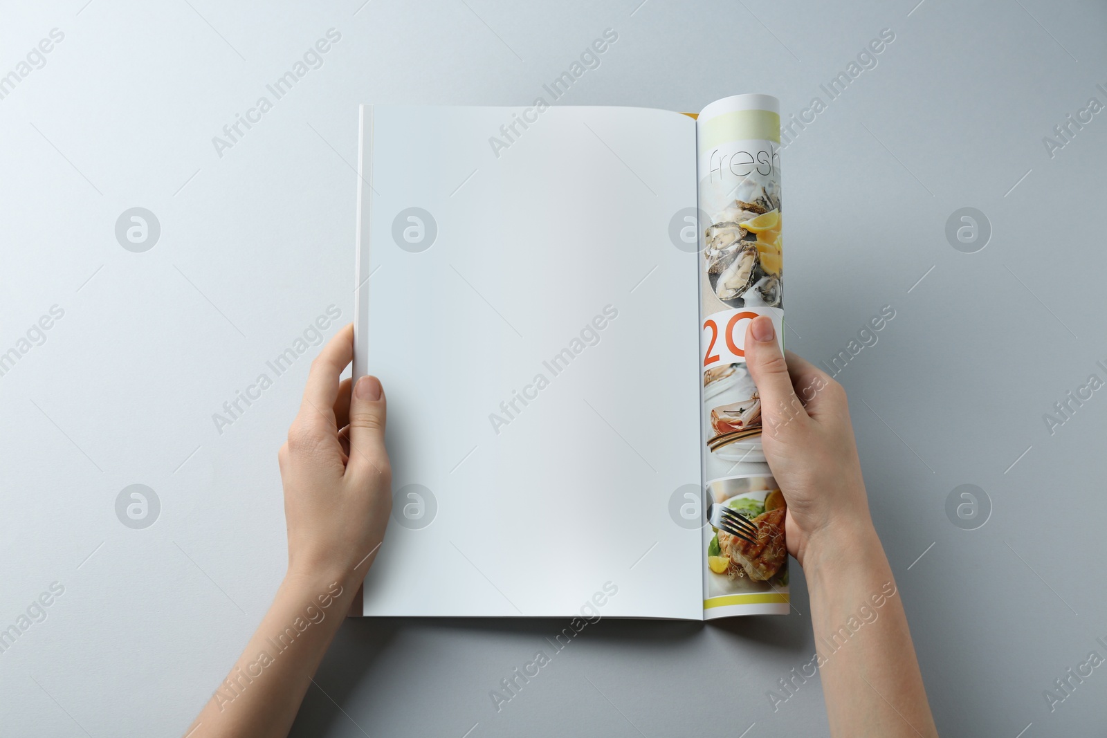 Photo of Woman reading magazine on grey background, closeup. Mockup for design