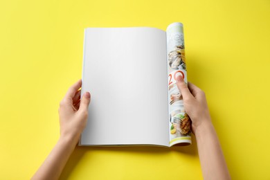 Photo of Woman reading magazine on yellow background, top view. Mockup for design