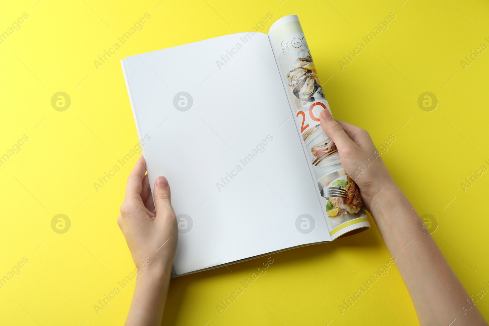 Photo of Woman reading magazine on yellow background, top view. Mockup for design