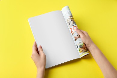 Photo of Woman reading magazine on yellow background, top view. Mockup for design