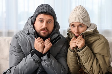 Cold symptom. Couple suffering from fever on sofa at home