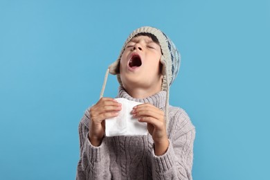 Photo of Cold symptom. Little boy with runny nose on light blue background