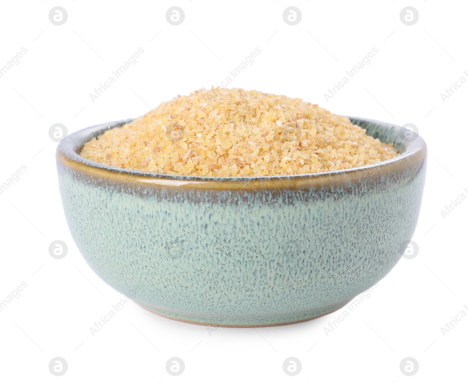 Photo of Raw wheat groats in bowl isolated on white