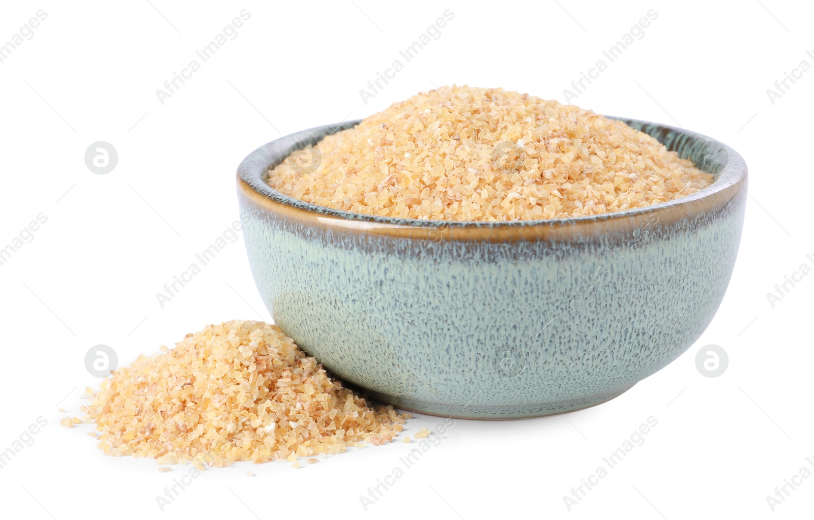 Photo of Raw wheat groats in bowl isolated on white