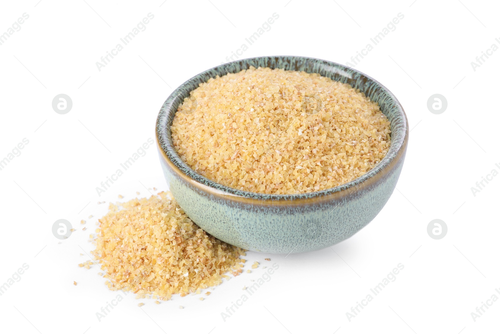 Photo of Raw wheat groats in bowl isolated on white