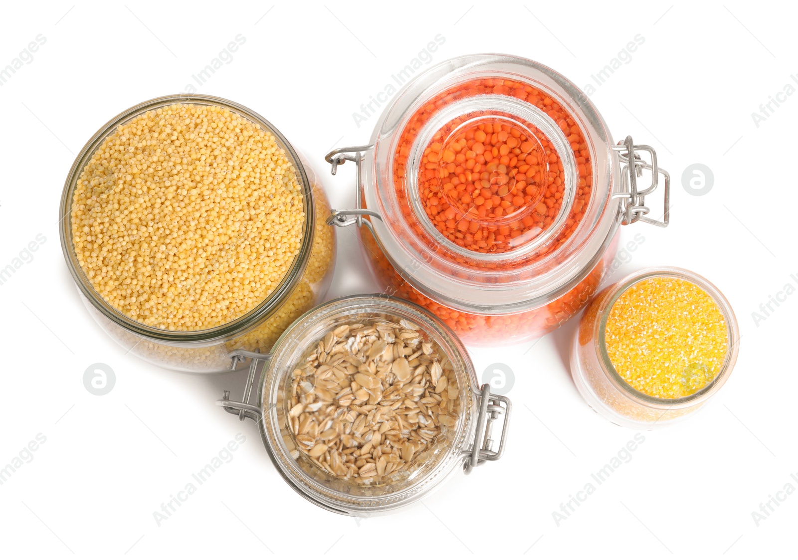 Photo of Different cereals and lentils in jars isolated on white, top view