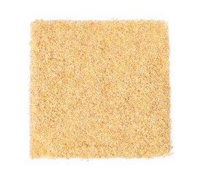 Photo of Pile of raw wheat groats isolated on white, top view