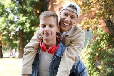 Photo of Family portrait of happy brothers outdoors on sunny day