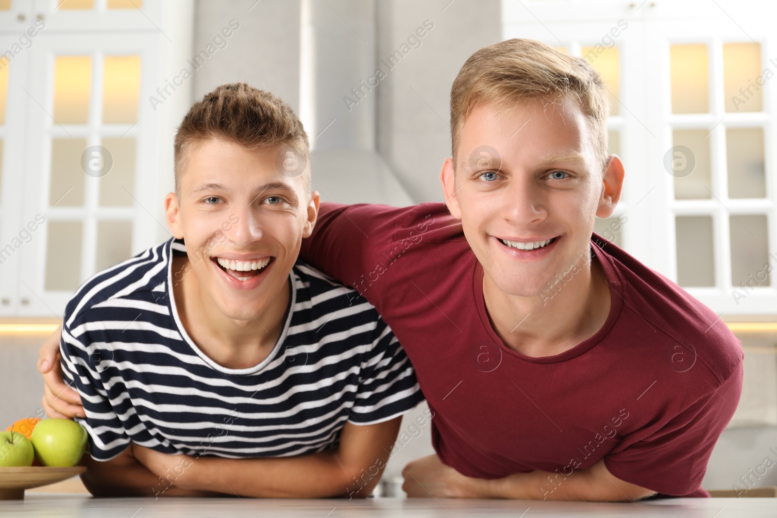 Photo of Family portrait of funny brothers in kitchen