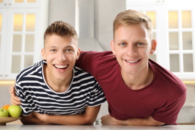 Family portrait of funny brothers in kitchen