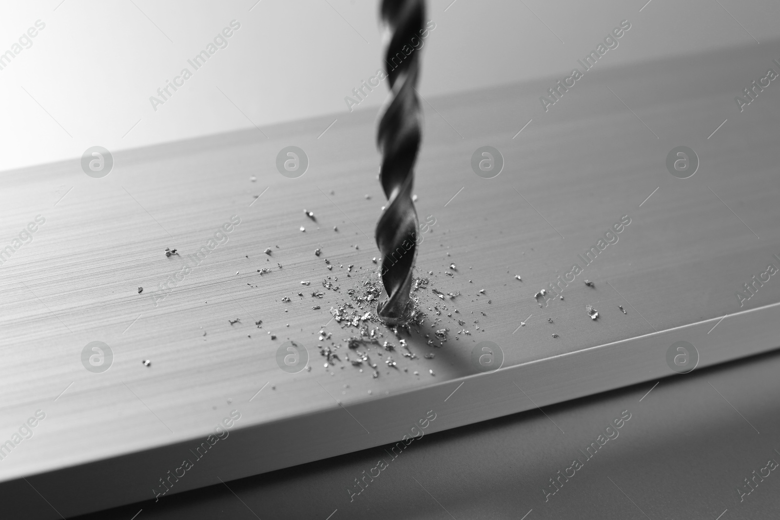 Photo of Drilling hole in plank on light table, closeup