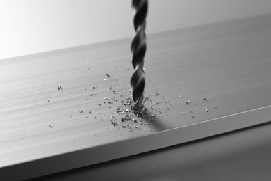 Drilling hole in plank on light table, closeup