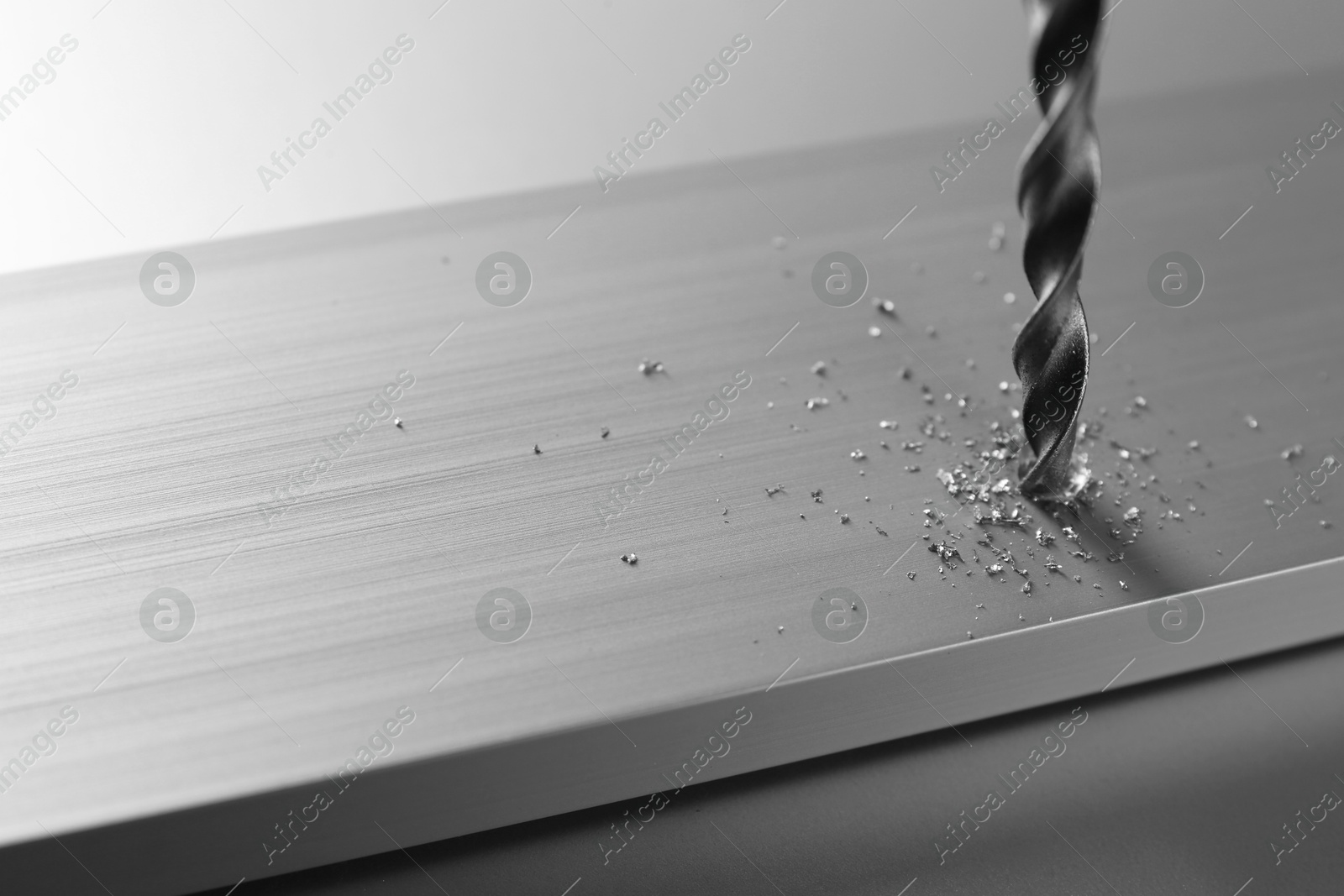 Photo of Drilling hole in plank on light table, closeup