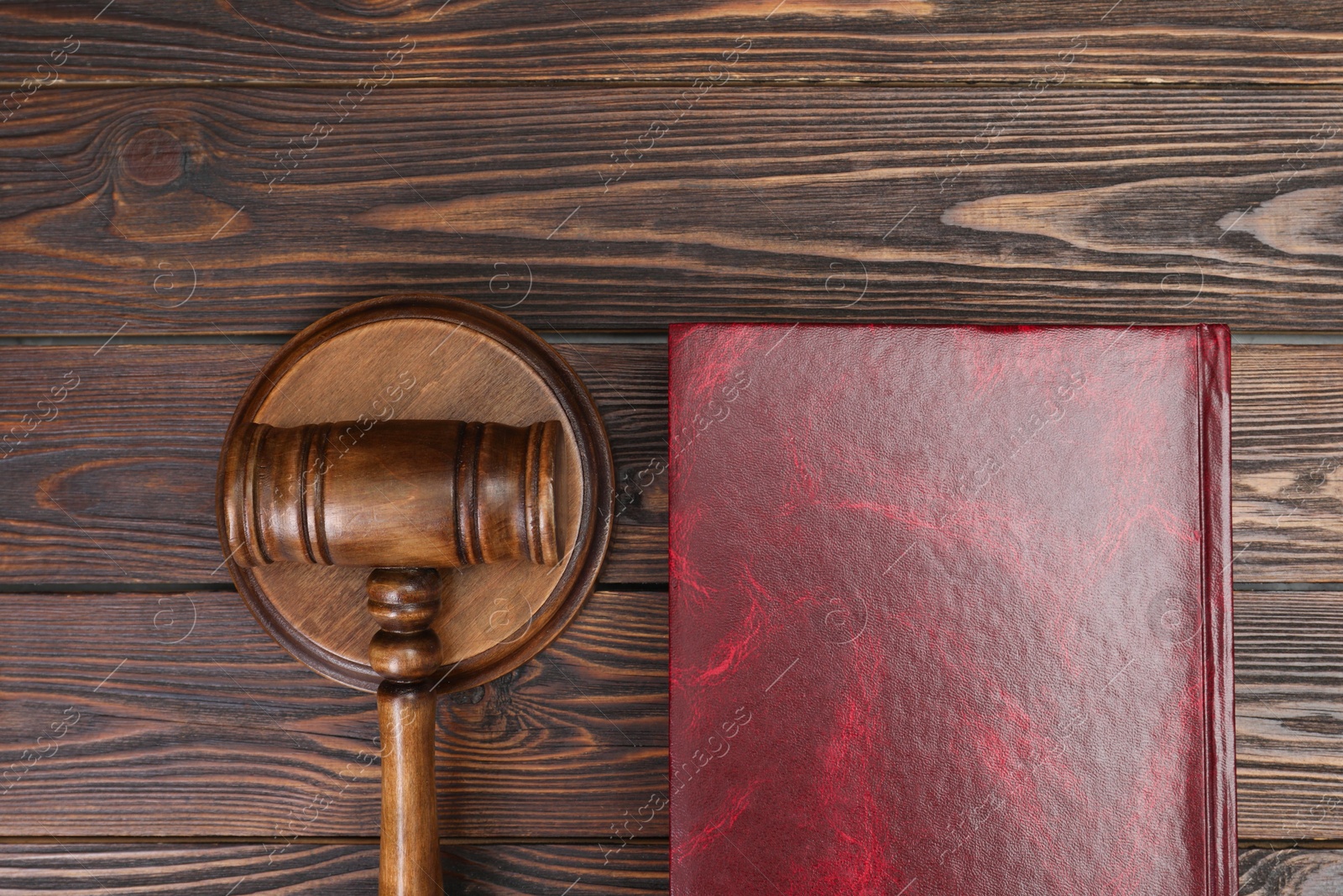 Photo of Book and judge's gavel on wooden table, flat lay