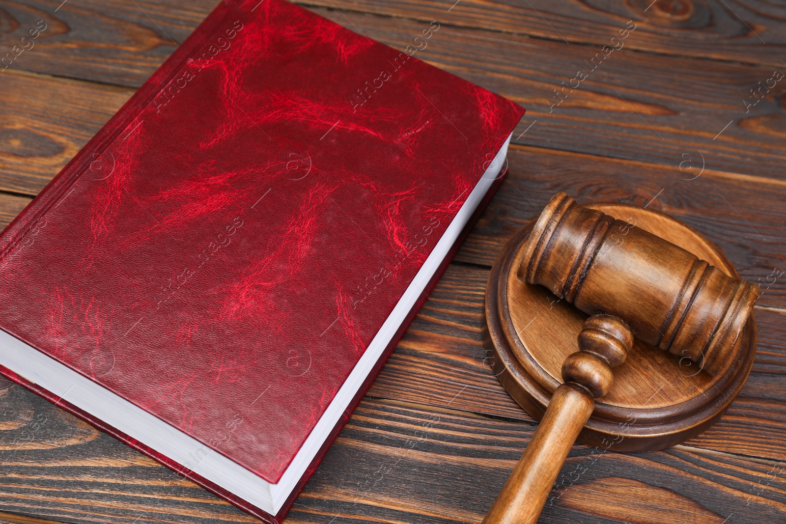 Photo of Book and judge's gavel on wooden table