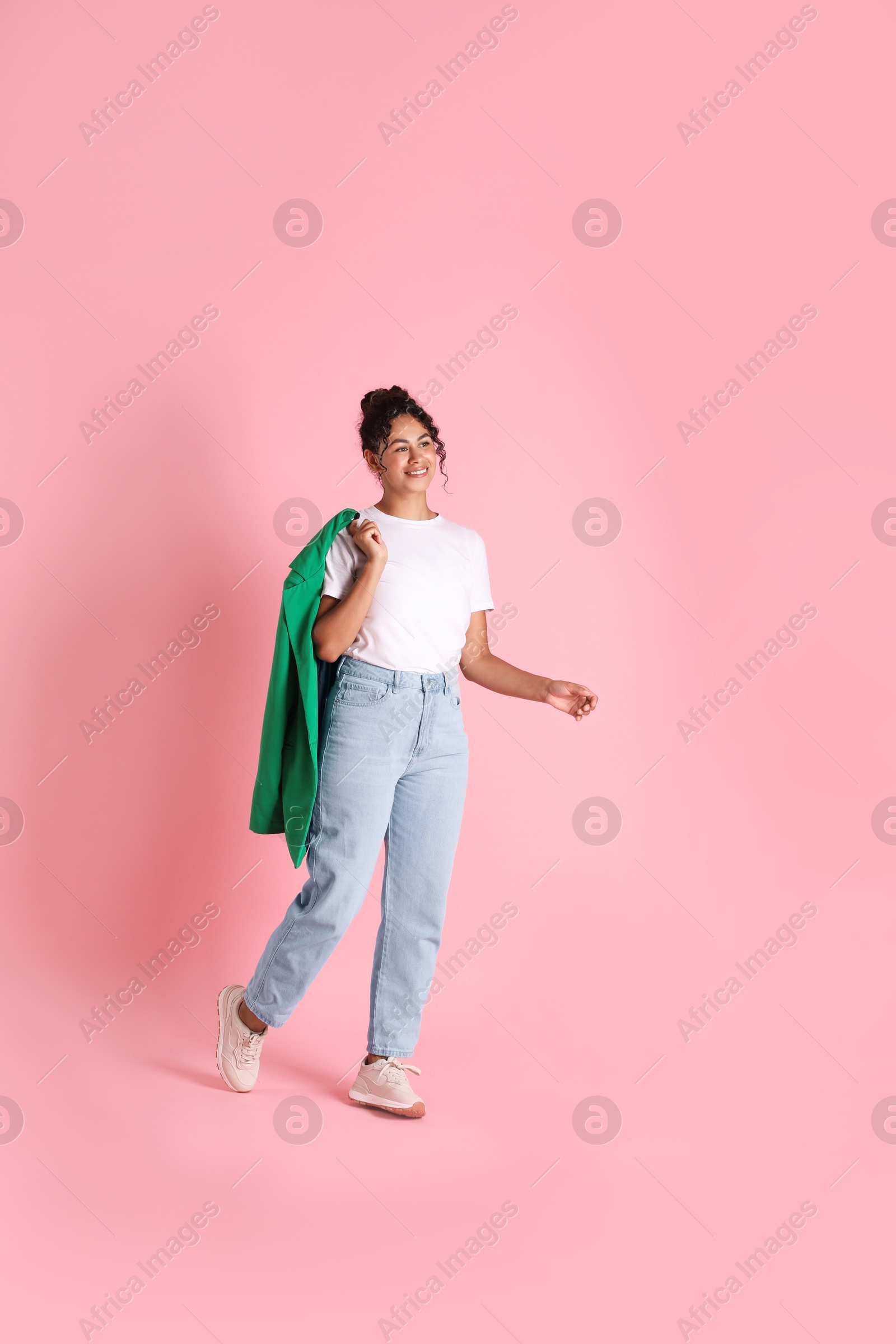 Photo of Beautiful woman with stylish jacket on pink background