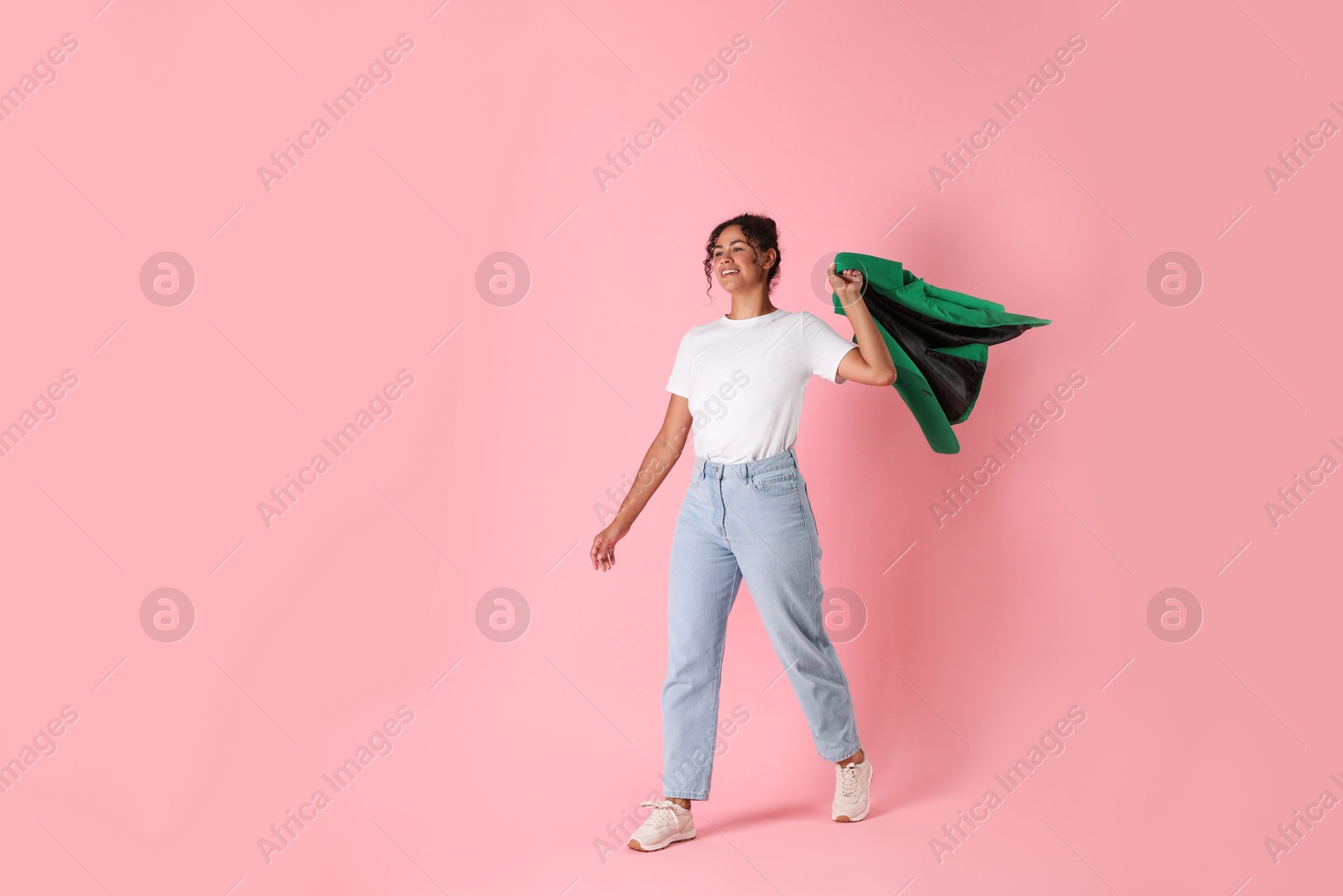 Photo of Beautiful woman with stylish jacket on pink background