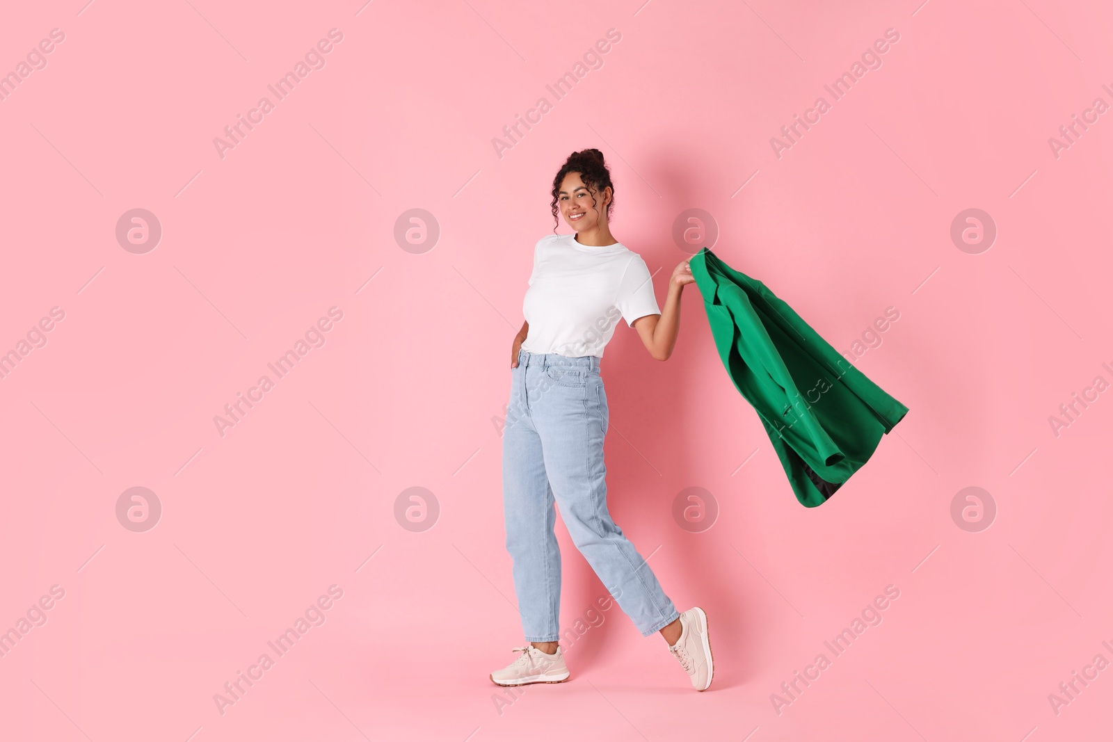 Photo of Beautiful woman with stylish jacket on pink background