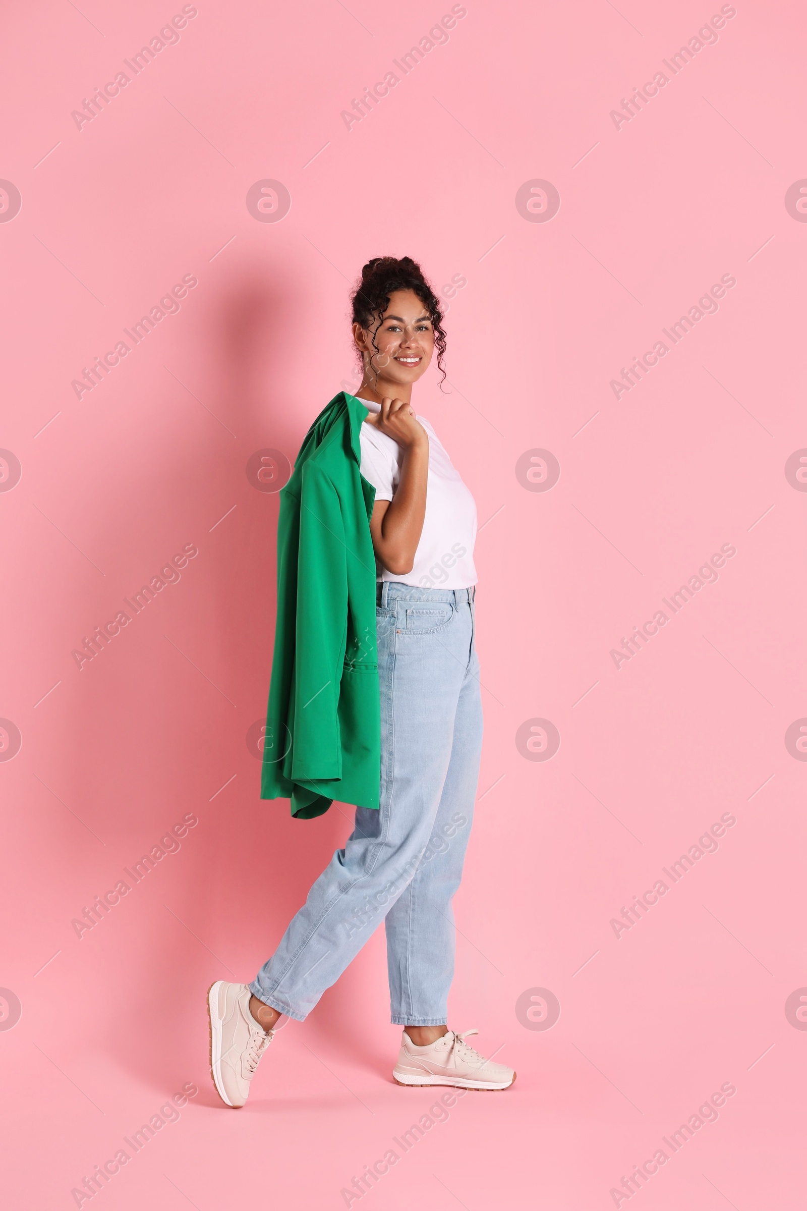 Photo of Beautiful woman with stylish jacket on pink background