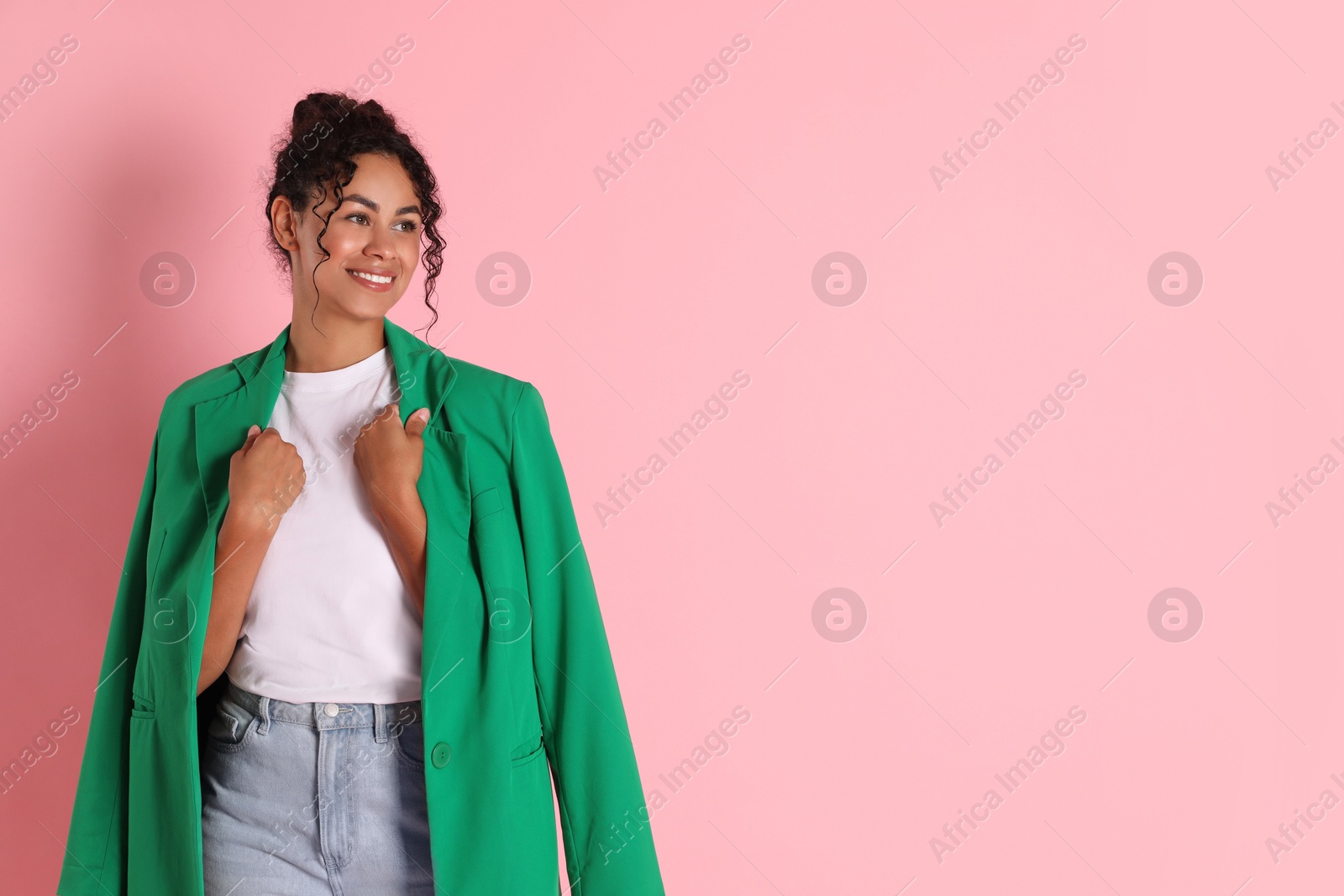 Photo of Beautiful woman with stylish jacket on pink background, space for text