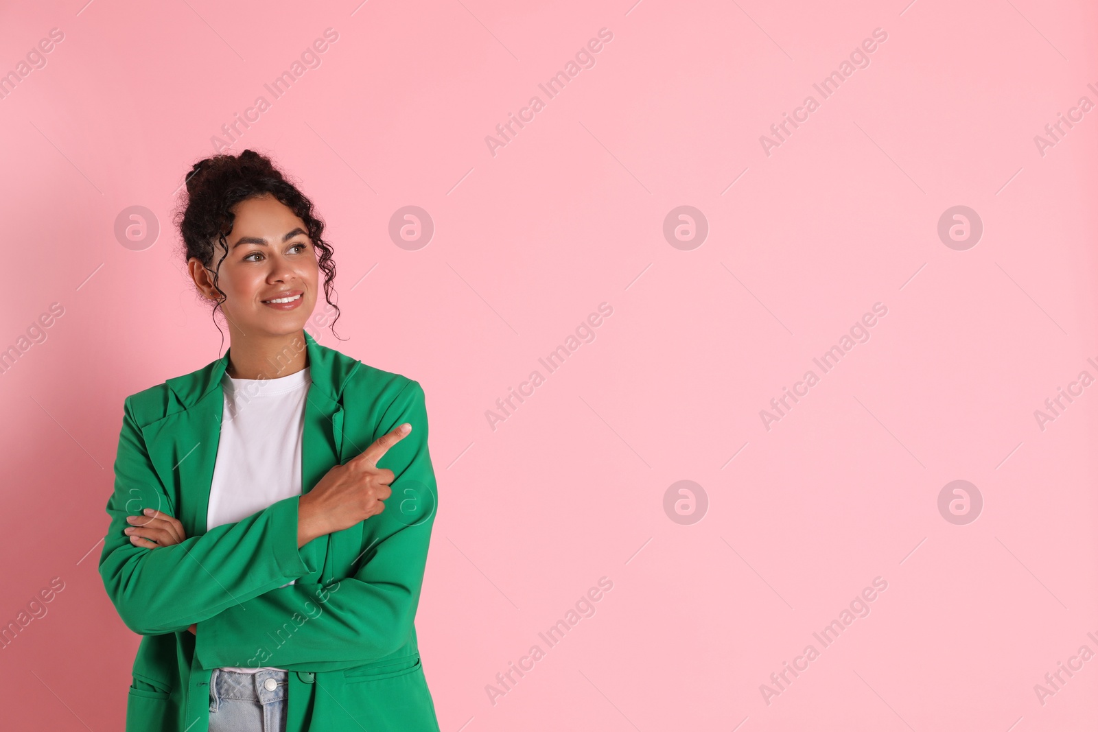 Photo of Beautiful woman in stylish jacket on pink background, space for text