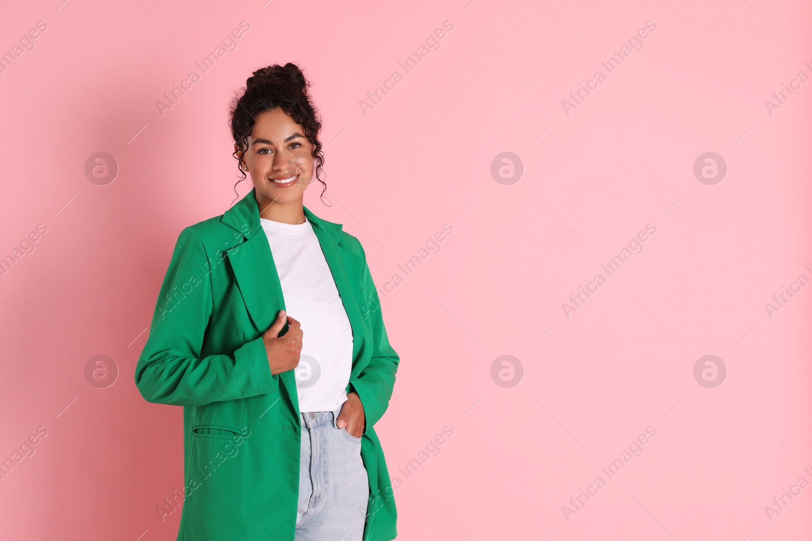 Photo of Beautiful woman in stylish jacket on pink background, space for text