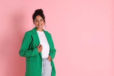 Beautiful woman in stylish jacket on pink background, space for text