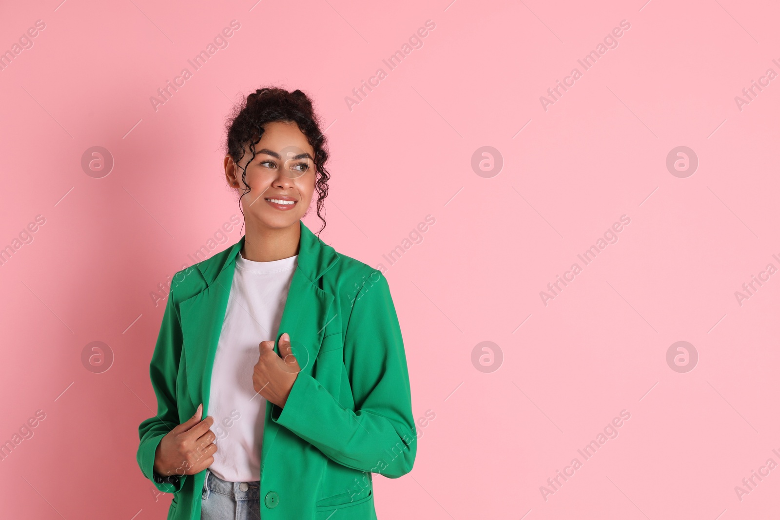 Photo of Beautiful woman in stylish jacket on pink background, space for text