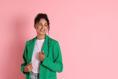 Photo of Beautiful woman in stylish jacket on pink background, space for text