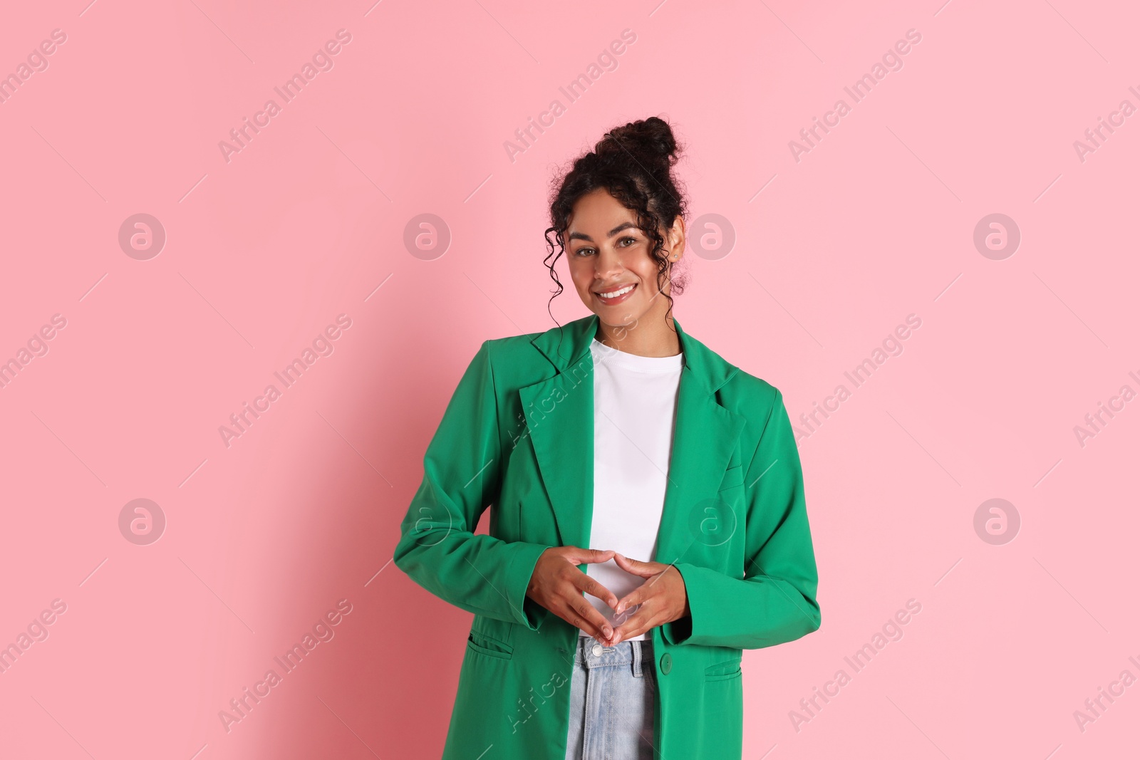 Photo of Beautiful woman in stylish jacket on pink background