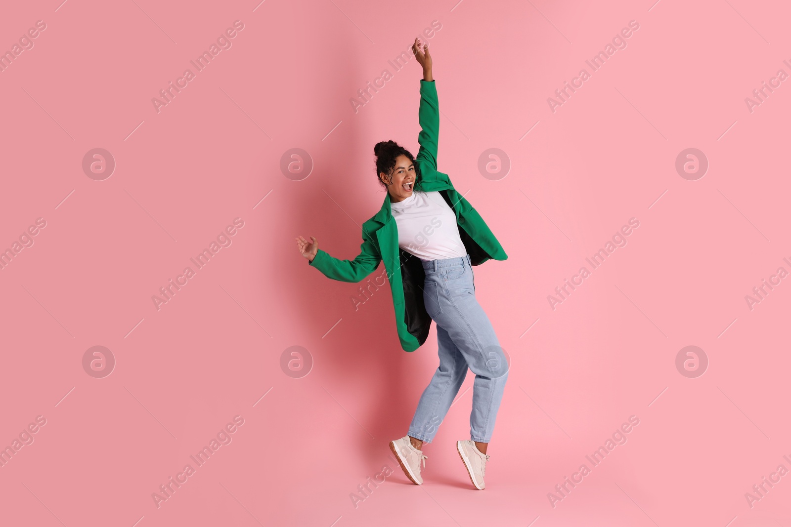 Photo of Beautiful woman in stylish jacket on pink background