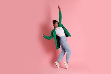 Photo of Beautiful woman in stylish jacket on pink background