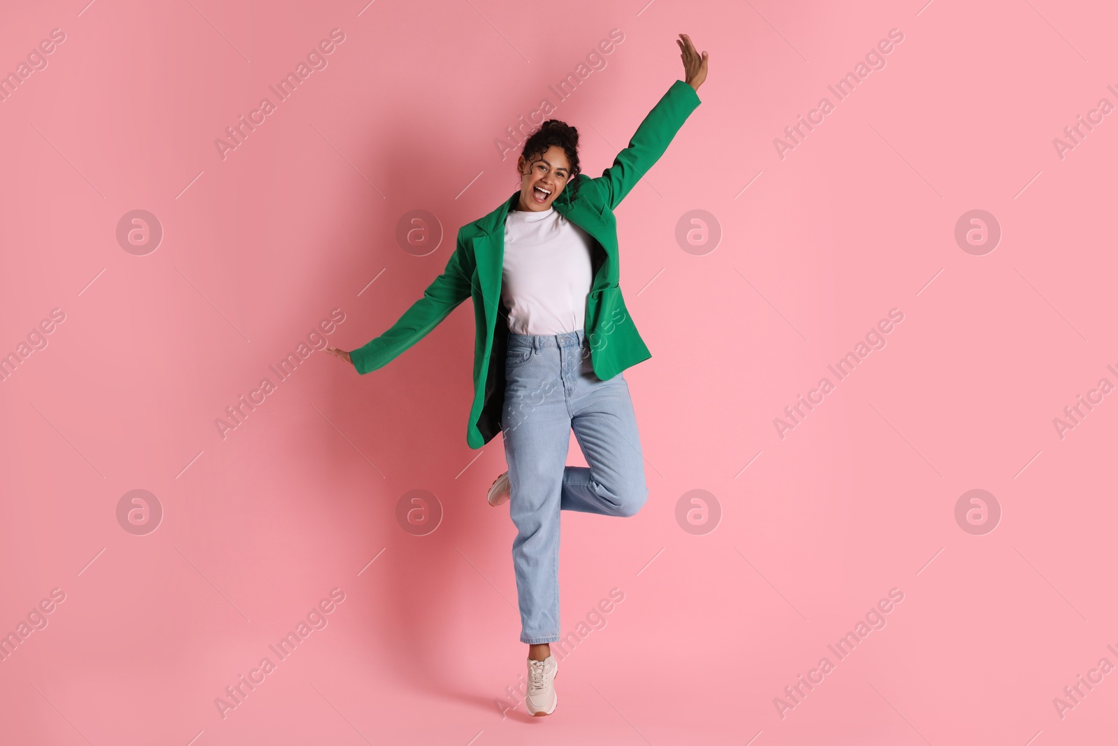 Photo of Beautiful woman in stylish jacket on pink background