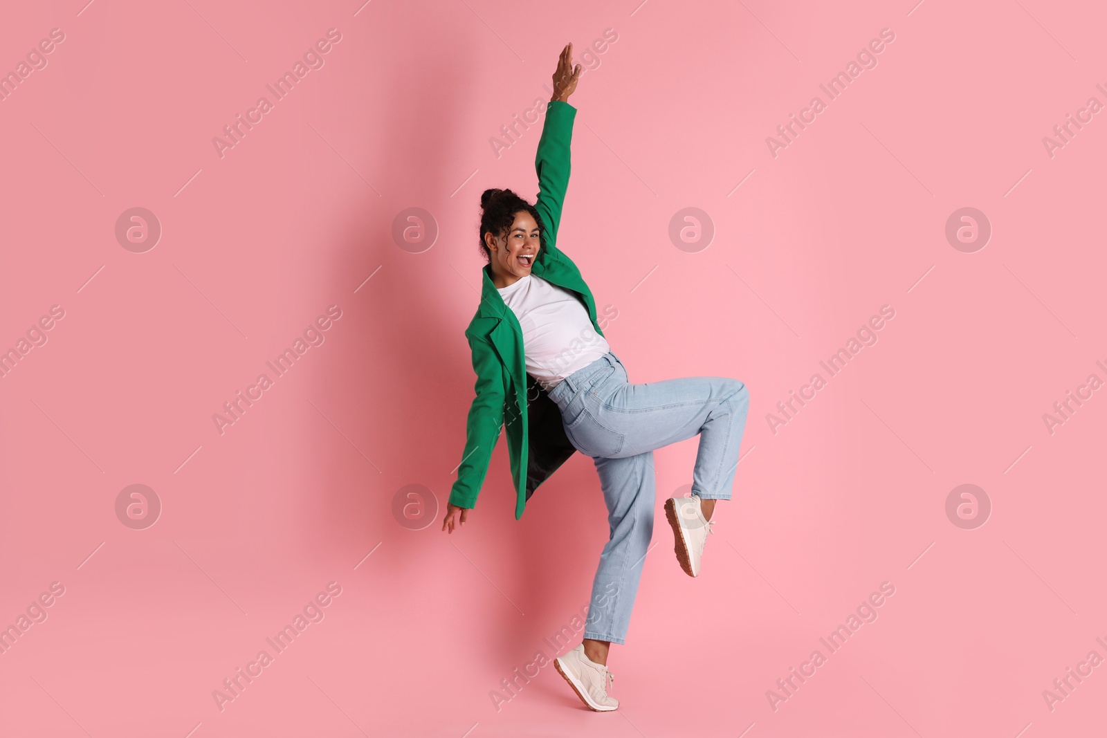 Photo of Beautiful woman in stylish jacket on pink background