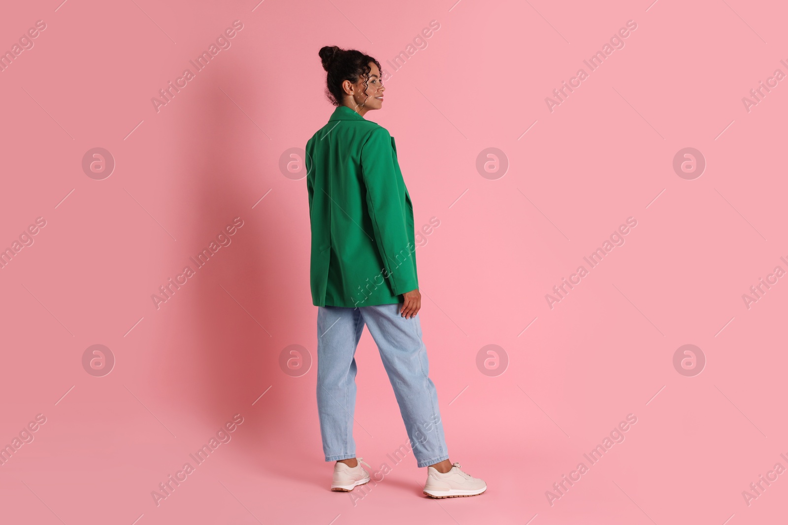 Photo of Beautiful woman in stylish jacket on pink background