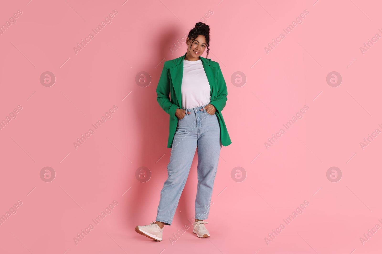 Photo of Beautiful woman in stylish jacket on pink background