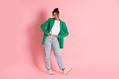 Photo of Beautiful woman in stylish jacket on pink background