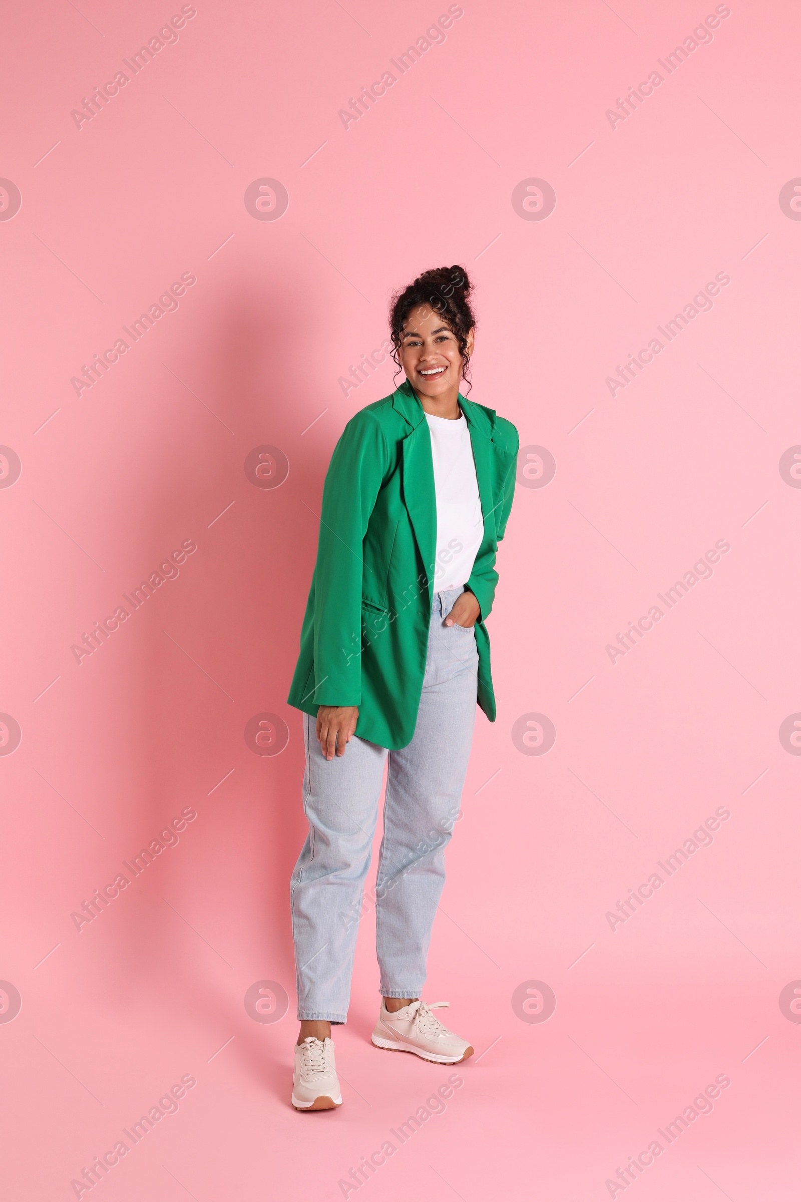 Photo of Beautiful woman in stylish jacket on pink background