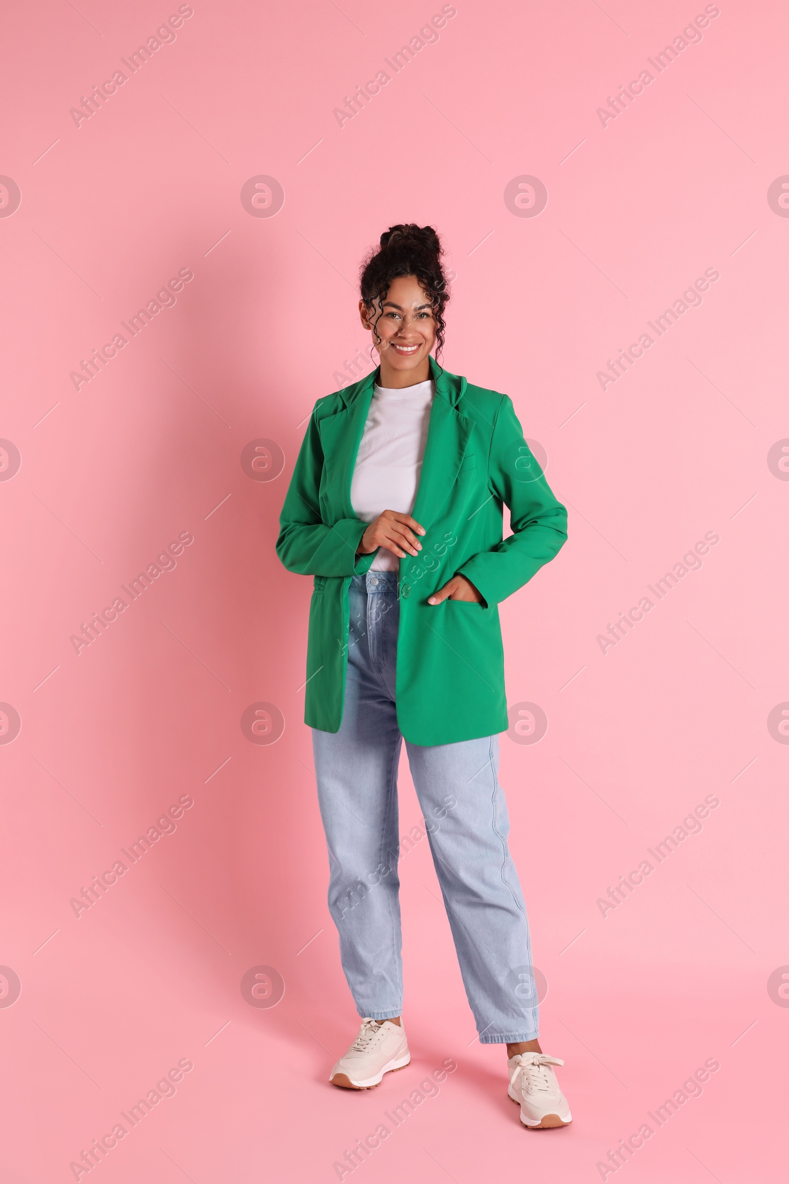 Photo of Beautiful woman in stylish jacket on pink background