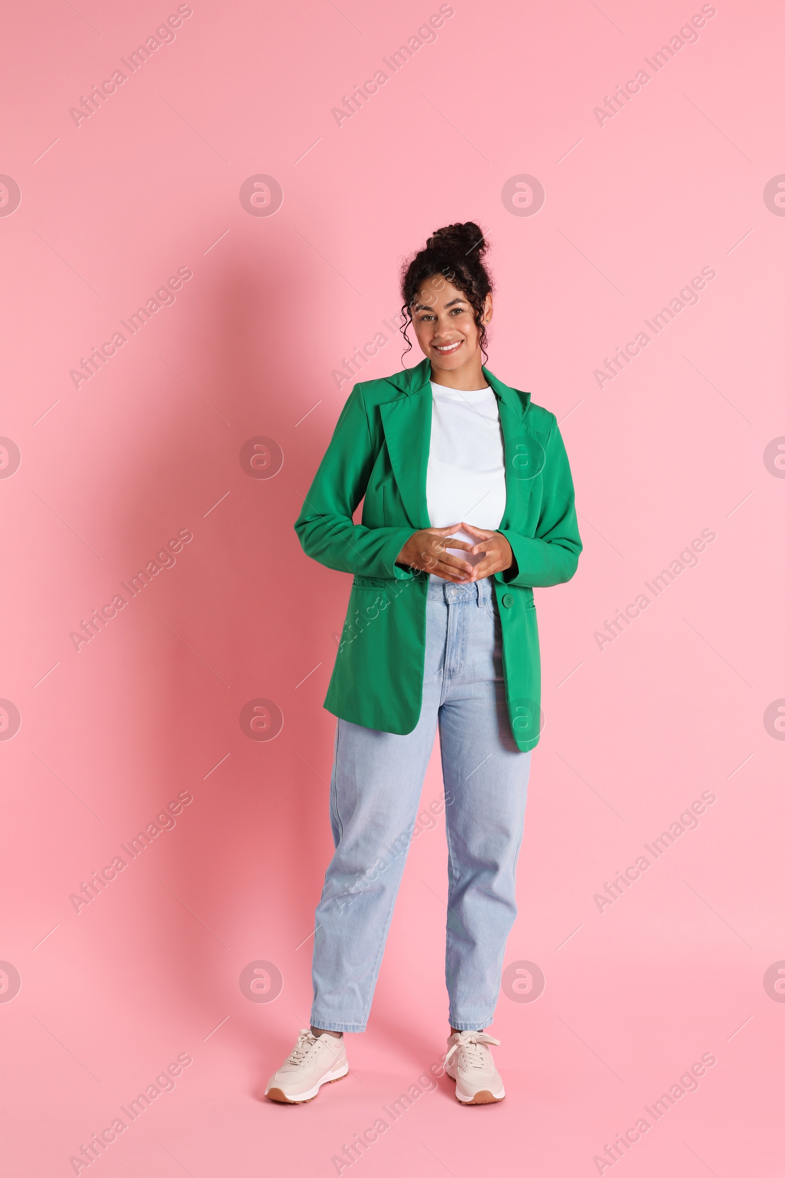 Photo of Beautiful woman in stylish jacket on pink background