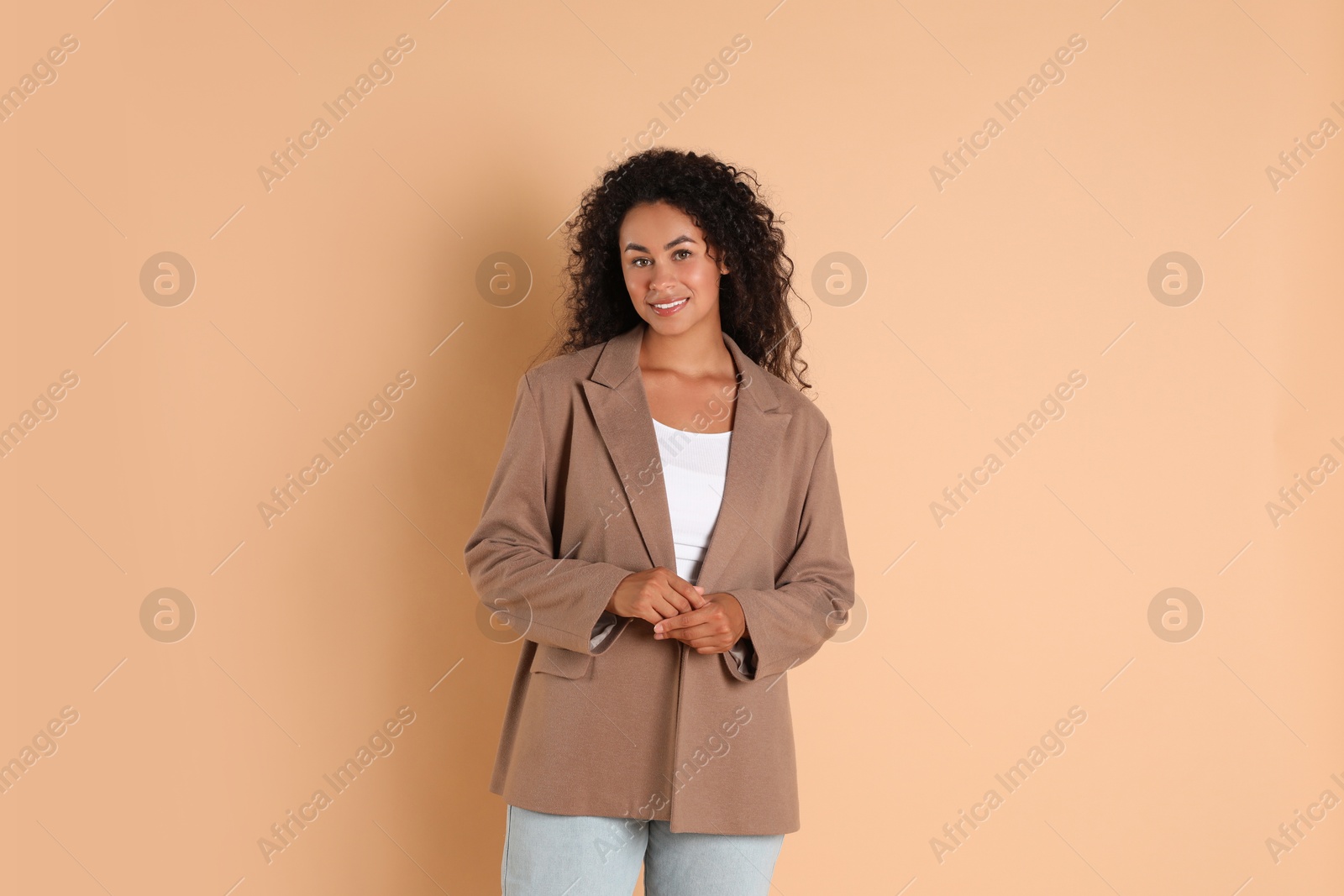 Photo of Beautiful woman in stylish jacket on beige background