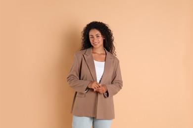 Photo of Beautiful woman in stylish jacket on beige background