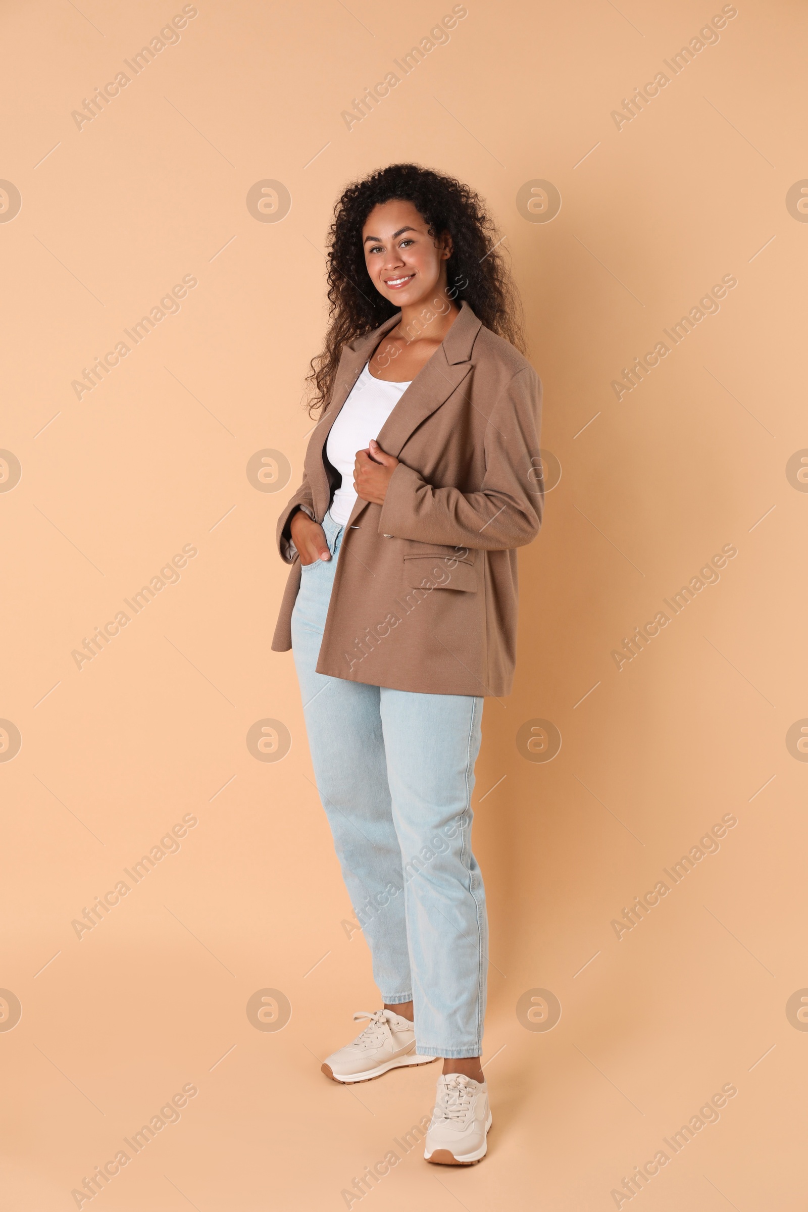 Photo of Beautiful woman in stylish jacket on beige background