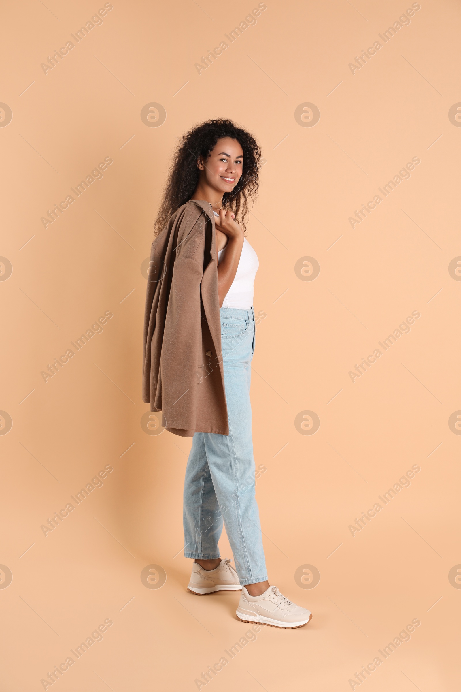 Photo of Beautiful woman in stylish jacket on beige background